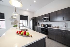 Buffalo apartment for rent - A modern kitchen with a white countertop and black cabinets.at The Annex Apartment, Buffalo, 14222