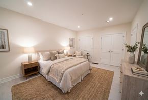 Buffalo apartment for rent - A bedroom with a bed, nightstand, and a mirror.