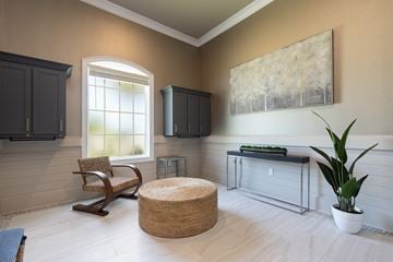 Cocoa apartment for rent - a living room with a chair and a table and a window