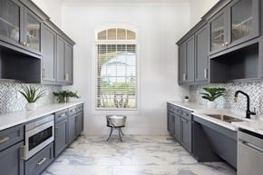 Cocoa apartment for rent - a modern kitchen with gray cabinets and a window