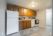 Brockport apartment for rent - A kitchen with wooden cabinets and a white refrigerator. at Willowbrooke Apartments & Townhomes, Brockport, NY, 14420