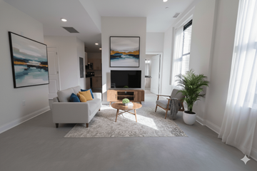 Buffalo apartment for rent - A living room with a white couch, a wooden coffee table, and a painting on the wall.