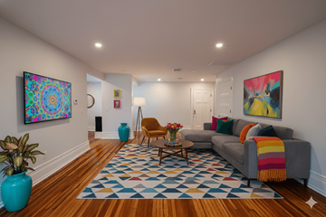 Buffalo apartment for rent - A living room with a grey couch and a blue vase.
