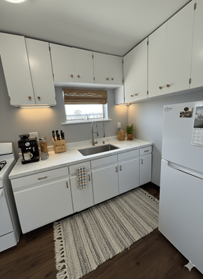 Buffalo apartment for rent - A kitchen with white cabinets and a white fridge.