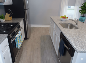 Buffalo apartment for rent - A kitchen with a black stove top oven and white cabinets.