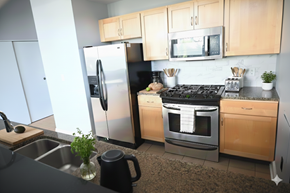 Buffalo apartment for rent - A kitchen with a refrigerator, oven, and microwave.