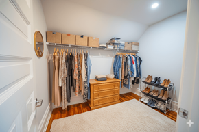 Buffalo apartment for rent - A white closet with clothes and shoes.