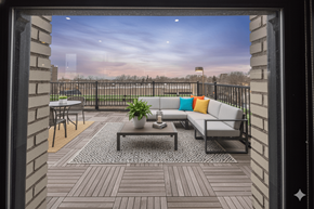 Buffalo apartment for rent - A balcony with a table, chairs, and a potted plant.