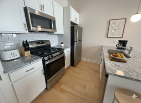 Buffalo apartment for rent - A kitchen with white cabinets and a granite countertop.