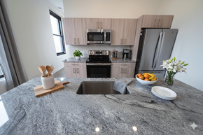 Buffalo apartment for rent - A kitchen with a granite countertop and a sink.