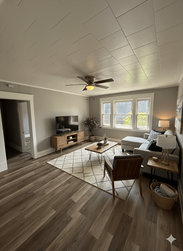 Buffalo apartment for rent - A living room with a ceiling fan and a rug on the floor.