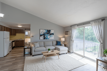Hamburg apartment for rent - A living room with a couch, a table, and a painting on the wall.