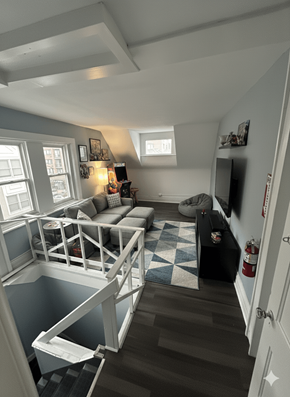 Buffalo apartment for rent - A living room with a couch and a fire extinguisher on the wall.