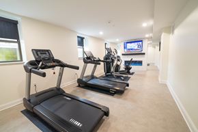 Buffalo apartment for rent - A spacious room with treadmills and a television.at The Annex Apartment, Buffalo, 14222