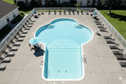 Fairport apartment for rent - A large outdoor swimming pool surrounded by lounge chairs.at Highview Manor Apartments, Fairport, 14450