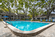 Tampa apartment for rent - Pool With Relaxing Chairs at Fernwood Grove Apartments, Tampa, 33614
