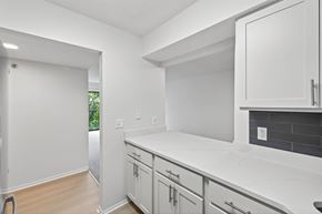 Bloomington apartment for rent - A kitchen with white cabinets and a white counter top.