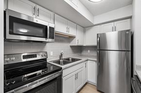 Eden Prairie apartment for rent - a kitchen with stainless steel appliances and white cabinets
