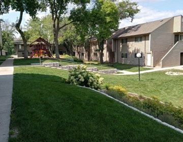 Stillwater townhouse for rent - a yard in a neighborhood with houses and a playground