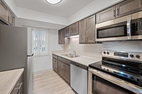 Eden Prairie apartment for rent - a kitchen with stainless steel appliances and wooden cabinets