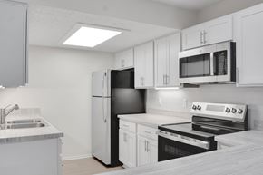 Hopkins townhouse for rent - A kitchen with white cabinets and appliances.