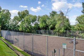 Minnetonka apartment for rent - A chain link fence surrounds a tennis court.