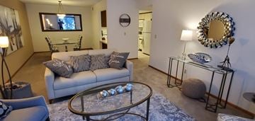 Bloomington apartment for rent - a living room with a couch and a table and a tv