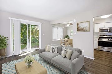 Schaumburg apartment for rent - A living room with a grey couch and a wooden coffee table.