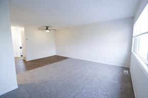 Minnetonka townhouse for rent - an empty living room with white walls and a ceiling fan