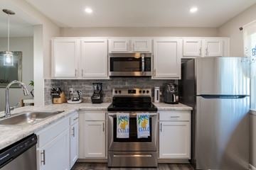 Manassas apartment for rent - A kitchen with white cabinets and stainless steel appliances.