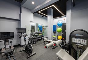 New Haven apartment for rent - A gym with a variety of equipment including treadmills, stationary bikes, and weight machines.