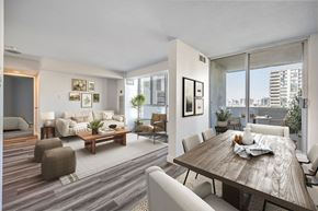 North York apartment for rent - A modern dining room with a wooden table and chairs.