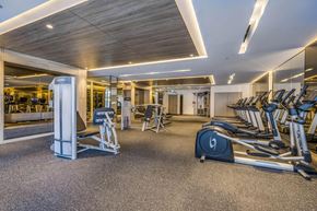 Toronto apartment for rent - A gym with treadmills, elliptical machines, and other exercise equipment.