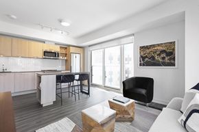 Toronto apartment for rent - A modern kitchen with a dining table and chairs.