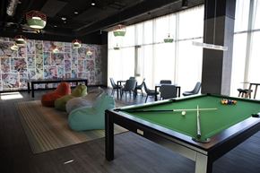 Toronto apartment for rent - A pool table in a room with a patterned wallpaper.