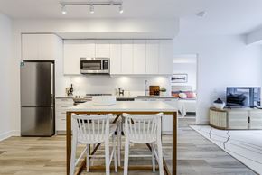 Newmarket apartment for rent - A kitchen with a table and chairs in the middle of it.