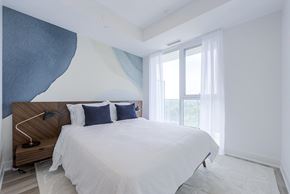 Newmarket apartment for rent - A bedroom with a large bed and a wooden headboard.