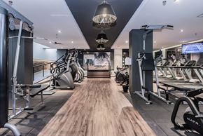 Montreal apartment for rent - A gym with a variety of equipment including treadmills, weights, and exercise machines.