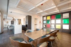 Calgary apartment for rent - A modern dining room with a table surrounded by chairs.