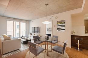 Montreal apartment for rent - A modern dining room with a glass table and chairs.