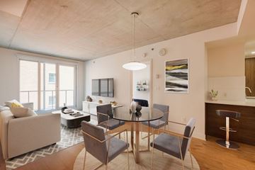 Montreal apartment for rent - A modern dining room with a glass table and chairs.