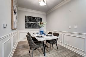 Atlanta apartment for rent - A dining room with a table set for two and a vase of flowers.