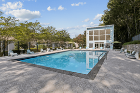 Decatur townhouse for rent - A large swimming pool with a blue water and a white building near it.