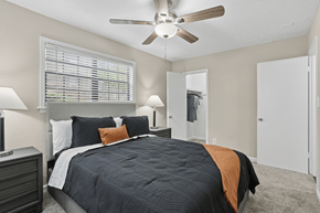 Decatur apartment for rent - A bedroom with a bed, nightstand, and a ceiling fan.