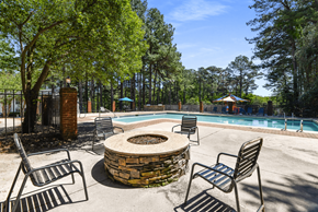 Austell apartment for rent - A pool surrounded by trees and chairs.