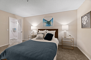 Austell apartment for rent - A bedroom with a bed, nightstands, and a painting on the wall.