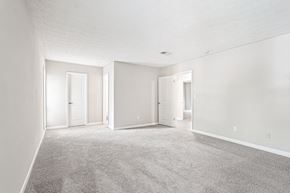 Atlanta apartment for rent - A spacious room with carpeted floor and three doors.