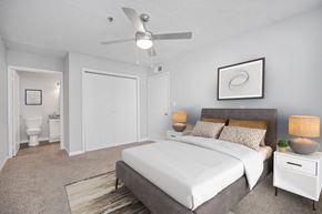 Lithonia apartment for rent - a bedroom with a white bed and a ceiling fan