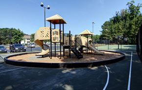 Decatur apartment for rent - a playground with two slides on a roundabout in a parking lot