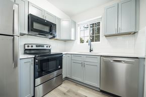 Riverdale townhouse for rent - A kitchen with a stainless steel refrigerator, oven, and microwave.